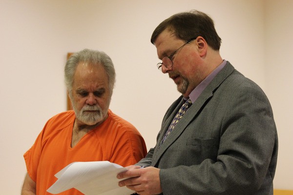 Robert “Al” Baker listens to attorney Tom Pacher during his murder trial in 2013.