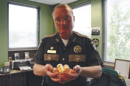 Island County Sheriff Mark Brown displays an assortment of prescription pills that will become part of 'Take Back Day' Sept. 25.