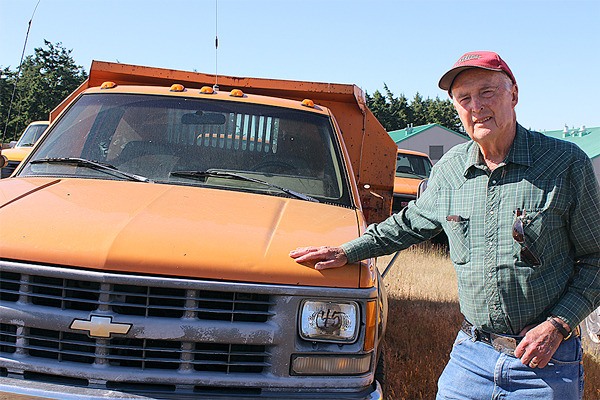 Auctioneer Harold Mather shows off one of the trucks being auctioned off by local agencies at 10 a.m. Saturday.