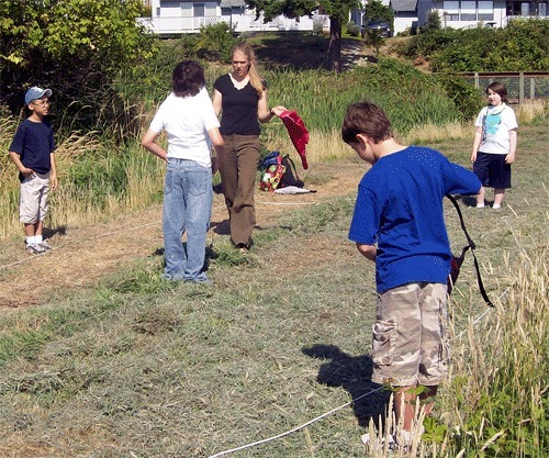 Teacher Tillie Scruton directs children in an activity during the Junior Naturalist Program last year.  Scruton grew up exploring the outdoors on Waldron Island.