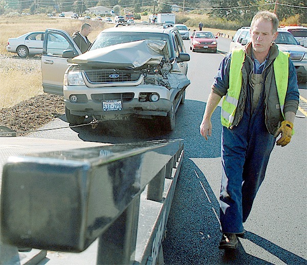 Tow-truck driver Gary Kilcup hooks up a 2002 Ford Explorer involved in a two-car collision on Highway 20 Monday. The accident closed the northbound lane for about an hour.