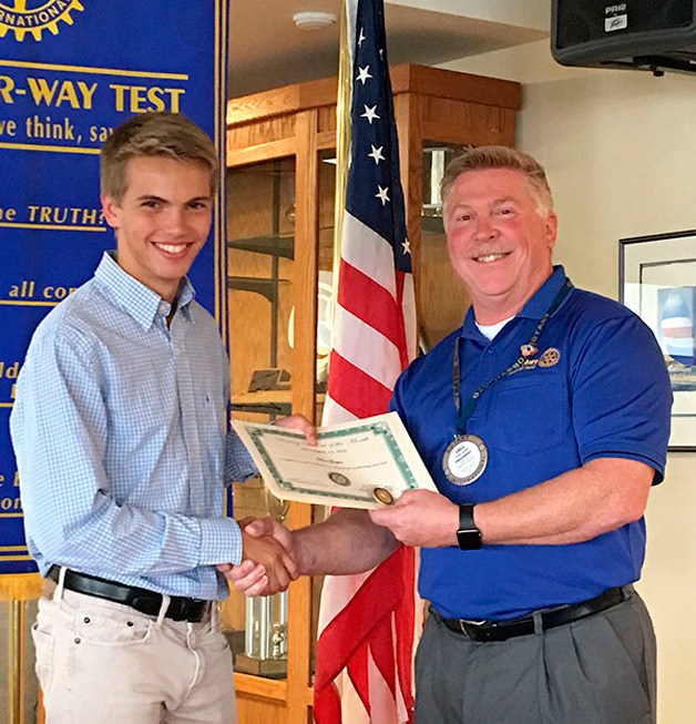Ben Gasper receives a certificate for earning Student of the Month from Rotary President Greg Smith.