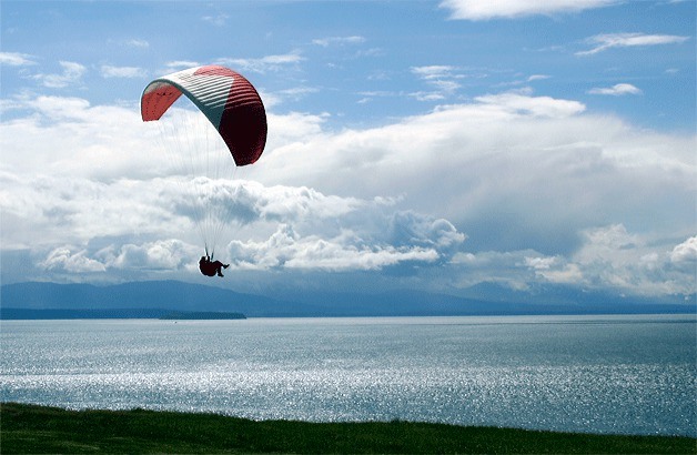 Coupeville resident Jim Martyn soars above the bluff near the gun batteries at Fort Ebey State Park. The open area near the gun emplacement is a popular spot from which paraglider pilots take off and land.