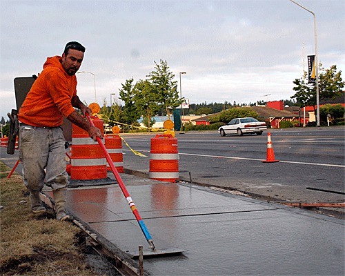 Eddie Velasco of Farrow Construction installs a new sidewalk at the intersection of Highway 20 and Whidbey Avenue. It’s part of a summer-long project to repave Highway 20 through Oak Harbor. Construction is scheduled to wrap up in the fall.