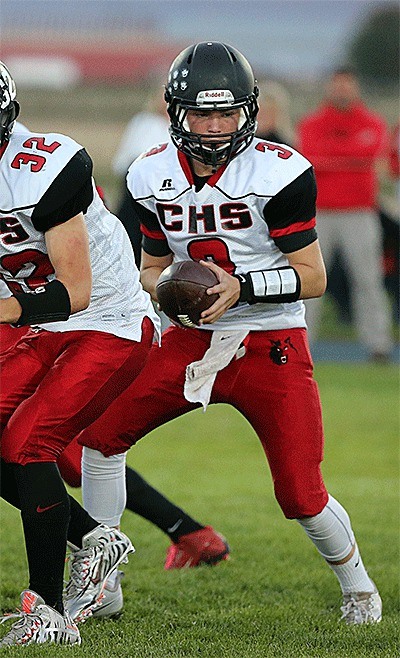 Hunter Downes prepares to hand off in the La Conner game Friday.