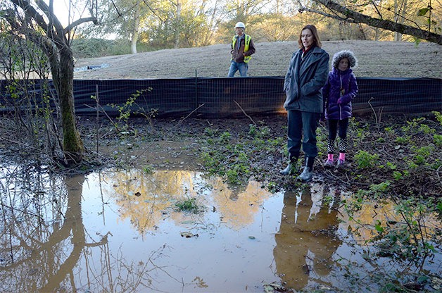 Freeland property owner Minda Wicher and her daughter inspect flooding on their land earlier this week. Gary Hays