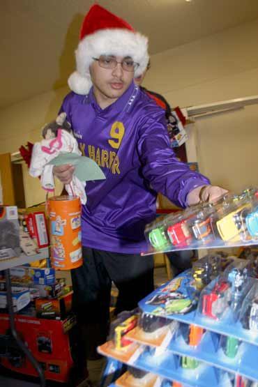 Volunteer Vance Freitas selects gifts for children in need from among the hundreds of toys