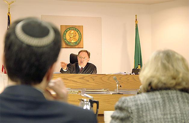 Island County District Court Judge Bill Hawkins discusses subpoenas during a hearing Monday on a fourth-degree assault case involving a hospital administrator and a patient.