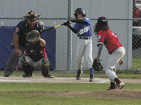 The Dodgers' Austin Boesch singles to right field against Central Whidbey early in the Andrade Tournament. The Dodgers went on to finish third in the 10-team tournament.