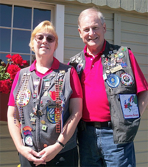 Martha and Curt Myron stand outside the Coupeville Recreation Hall where registration will take place for the weekend's events. The couple's vests are inundated with patches and pins commemorating completed walks from years past.