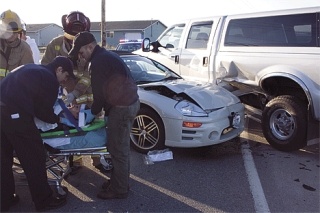 Emergency personnel secure 15-year-old Stephanie Bigelow to a gurney before transporting her to Whidbey General Hospital