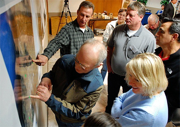 Duane Dillard and other Oak Harbor residents discuss potential places to build a new wastewater treatment plant at a Monday workshop designed for just that purpose.