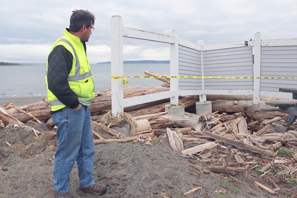Oak Harbor city parks director Hank Nydam surveys some of the damage caused by winter weather and two nasty spring storms last month. The windbreakers blocking the picnic tables were so damaged they’ll have to be removed.