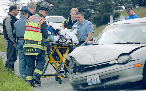 Paramedics from Central Whidbey Fire and Rescue and Whidbey General Hospital load an unidentified Oak Harbor woman into an ambulance Monday afternoon.