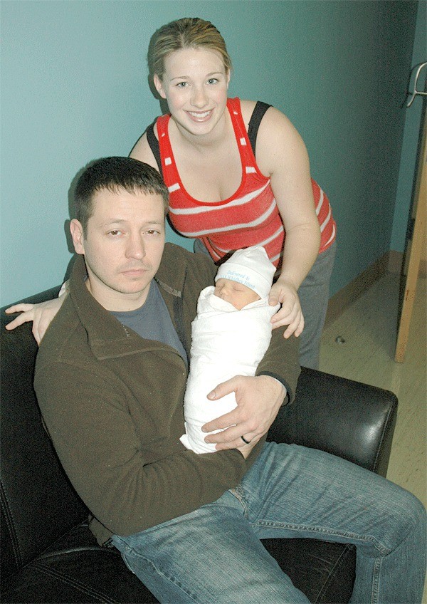 Aircrew Survival Equipmentman 2nd Class Michael Price holds his son