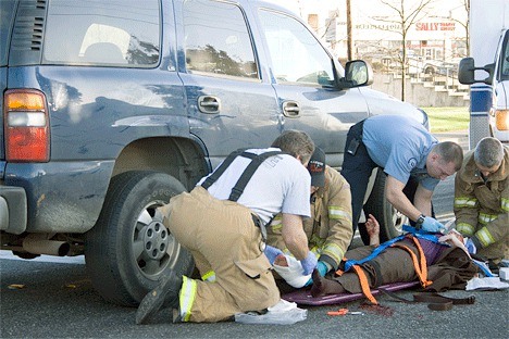 Oak Harbor firemen ready a 55-year-old female crash victim for transport to Whidbey General Hospital Monday morning after she was struck by a blue Chevy Tahoe. The incident occurred on highway 20 at the intersection with SW Erie Street. The driver of the Chevy apparently did not see the pedestrian who was walking in the crosswalk
