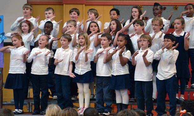 Oak Harbor Elementary School students sing one of several patriotic songs during a Veterans Day program.