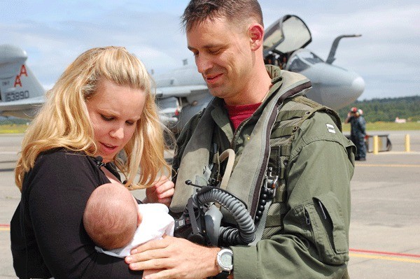 Janice Fatora presents seven-week-old Brendan to his father