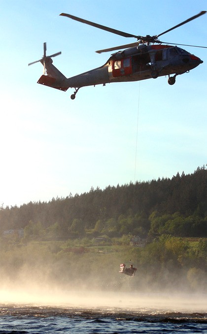 The Naval Air Station Whidbey Island Search and Rescue unit practices water rescue exercises at Campbell Lake Wednesday evening. North Whidbey Fire and Rescue attend the exercises as a precaution.