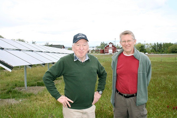 Port of Coupeville Executive Director Jim Patton and John Hastings of Island Community Solar stands in front of panels that were recently installed at the Greenbank Farm.