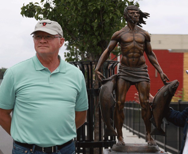 Wayne Lewis stands by the “Island Spirit” statue he sculpted and donated to the City of Oak Harbor during a dedication for the artwork Thursday. The statue is located on the sidewalk on S.E. Pioneer Way near Dock Street.