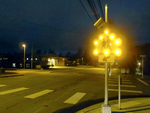 A pedestrian sign flashes warning motorists of people crossing Whidbey Avenue at the corner of Izett Street. The city of Oak Harbor partnered with the Oak Harbor School District to better illuminate crosswalks near schools in town.