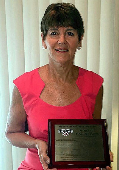 Darlene Brasch holds her Northwest Nazarene University Athletic Hall of Fame plaque she received Nov. 13.
