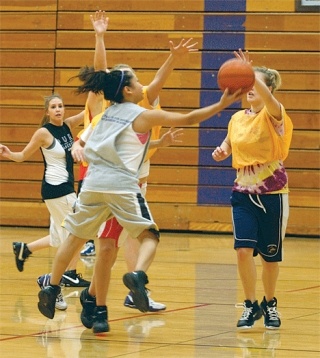 Oak Harbor senior Cheyenne Tubo drives hard to the basket and gets off  a scoop shot good for two points during an early-season practice session.
