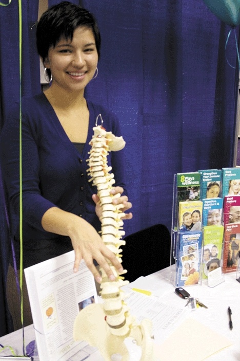 Dr. Cassandra Peterson  holds a model of the human spine. She opened Peterson Family Chiropractic in October