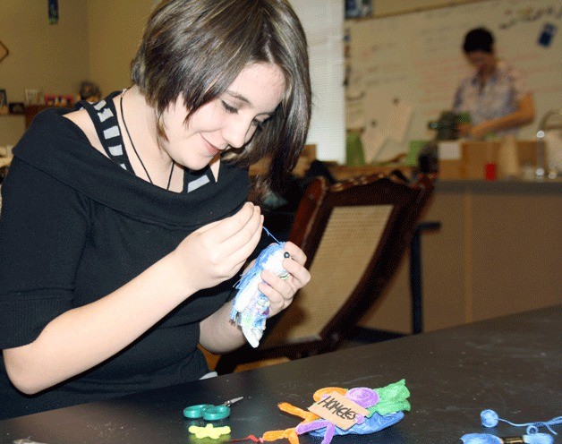 Coupeville High School sophomore Aly Dehay works on miniature puppets in her advanced art class.