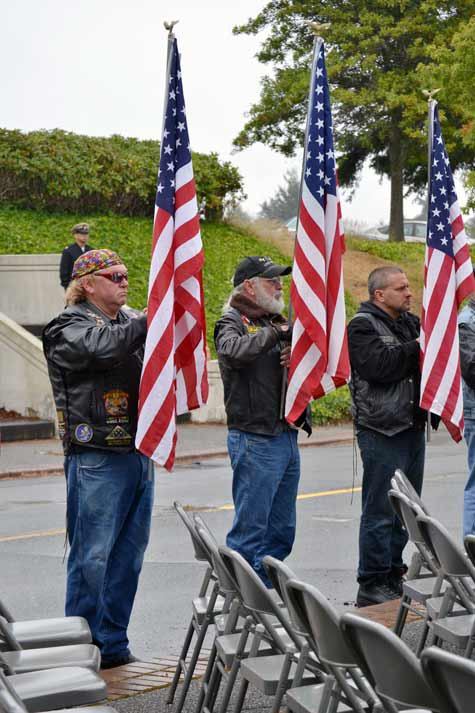 Members of the Patriot Guard Riders hold American flags during Friday’s POW/MIA remembrance ceremony on the NAS Whidbey Island Seaplane Base.