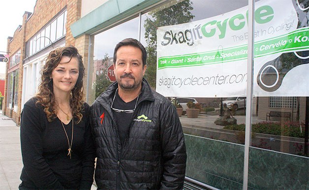 Skagit Cycle owners Bernie and Gary Santiago stand outside the location of their new bike shop on Pioneer Way last week. The store is expected to open in June.