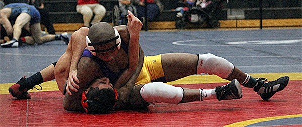 Oak Harbor's Jeremy Vester records a first-round pin over Cedarcrest's Marcos Pena. Vester went on to win the 138-pound class and the tournament MVP award.