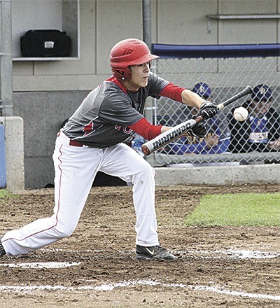 C.J. Smith puts down a bunt in the Wolves' state tournament game with Rochester Saturday.