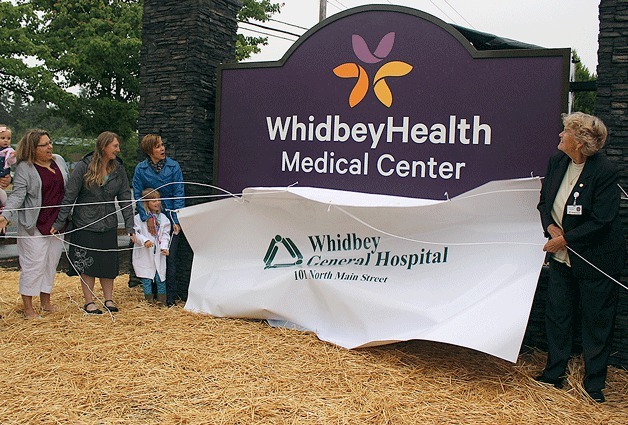 The hospital is now officially WhidbeyHealth Medical Center. The new sign was unveiled Monday morning with some helpers. From left to right:  Erin Hedrick; Kristine Young