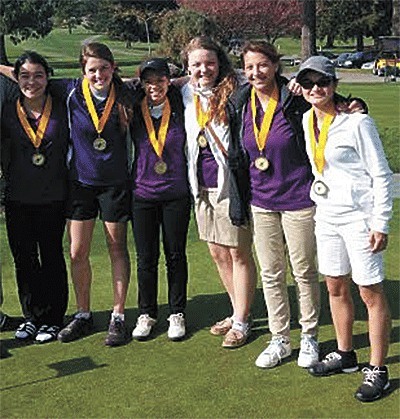 The Oak Harbor girls golf team shows off their fourth-place medals from the Burlington-Edison Invitational. From left