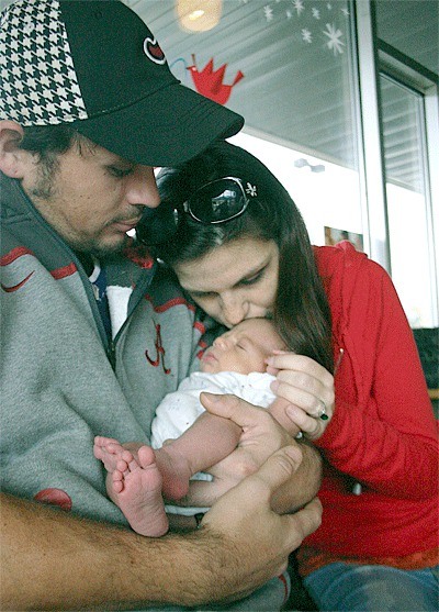 Travis and Stephanie Ellison hold their new son