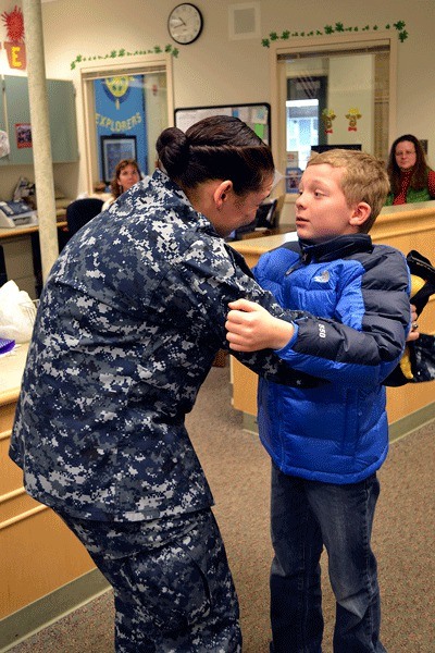 Nine-year-old Nathan Dixon gives his mom