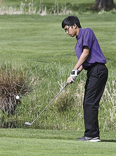 T.J. Cortez chips to the green for Oak Harbor Friday.