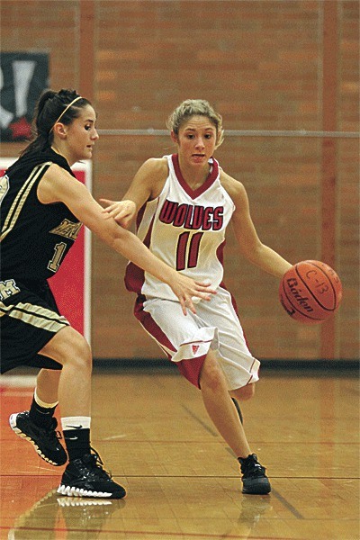 Cassidi Rosenkrance dribbles by the pressure of a Meridian defender.