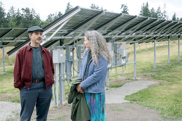 Langley resident Paul Mathews and Clinton resident Enid Braun talk solar energy during an event commemorating the new arrays installed at the Greenbank Farm.