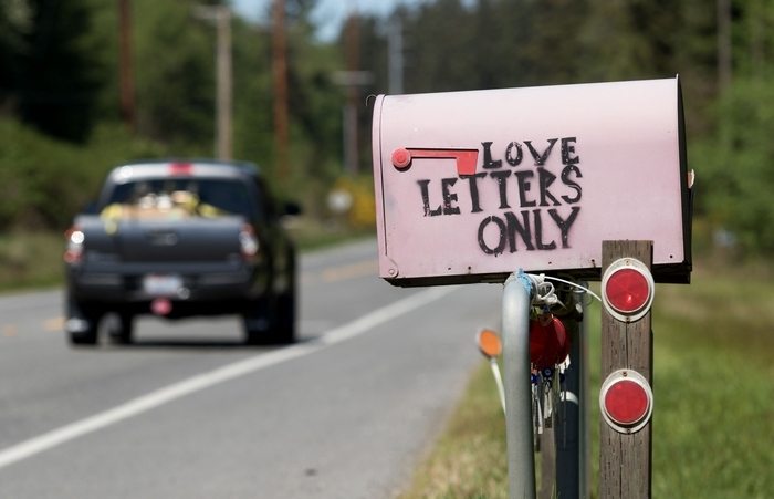 A truck passes by a pink “Love Letters Only” mailbox on Highway 525 on Whidbey Island near Greenbank. The pink mailbox is owned by Stacy Anderson