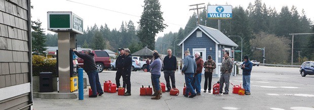 South Whidbey residents wait in line for ethanol-free fuel at the Valero gas station in Clinton Wednesday. More than 4