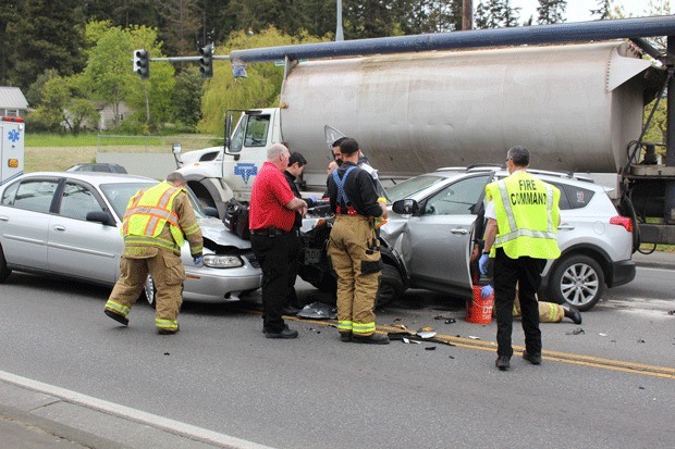 Firefighters respond to the scene of an accident on Highway 20 at Erie Street in Oak Harbor this afternoon.