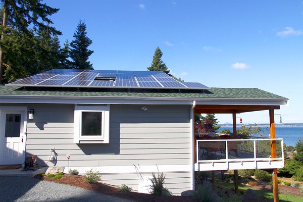 The south-facing roof of this home is covered with solar panels that generate 275 watts each. Along with a heavily windowed eastern side and special wall and roof construction