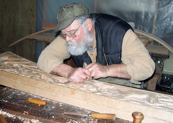 Longtime Greenbank resident Glen Russell works on a door span for the Coupeville Library. The well-known wood carver died in his sleep Monday