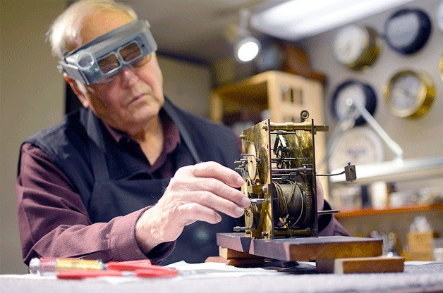 Herb Helsel works on an antique clock in his shop