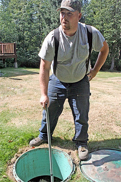 Mark Lenocker inspects a leaking septic mound system at a North Whidbey home.