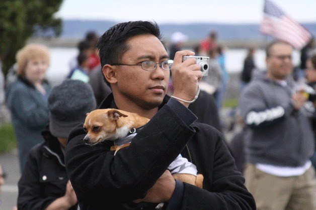 A spectator and his dog take in the Holland Happening grand parade in downtown Oak Harbor in April