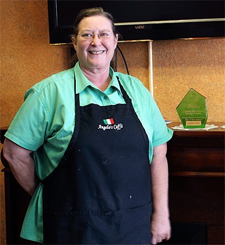 Angelo’s Caffe owner Kathy Collantes displays her Green Business Award on a fireplace mantel in the restaurant. Angelo’s has received two Green Business Awards from the City of Oak Harbor and is currently a pilot site for the Sustainable Whidbey Coalition’s new Green Seal program.